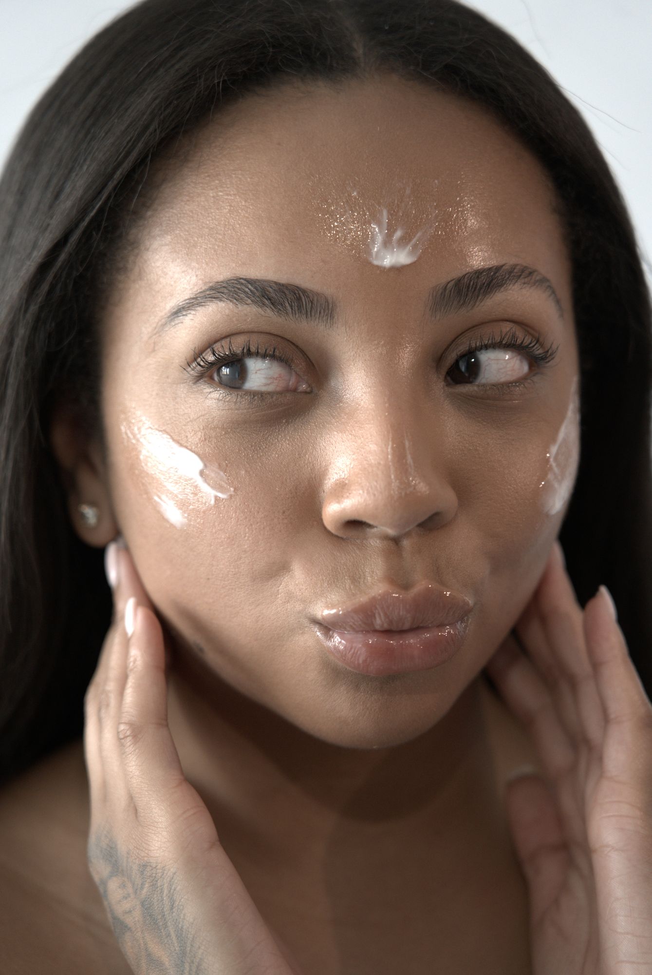 Tacha with skincare applied to her forehead and cheeks